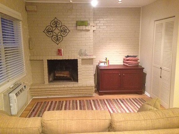 Living room with wood burning fireplace.