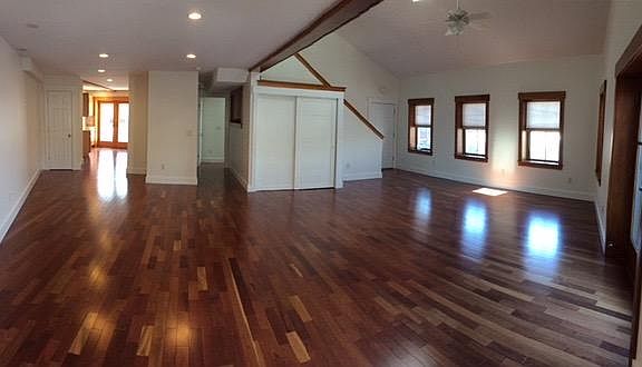 downstairs open concept living area. shown later in photo furnished. Hall in middle is to first level bedroom and 3/4 bath. double closet for coats and shoes. apartment entry door on right.