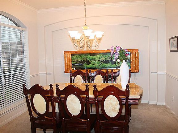 Crown molding,chair rails arches and large picture window lets you enjoy your family meals in style.