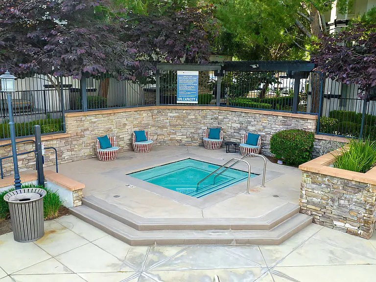 Cozy Hot Tub Area with Stone Detailing and Lounge Seating