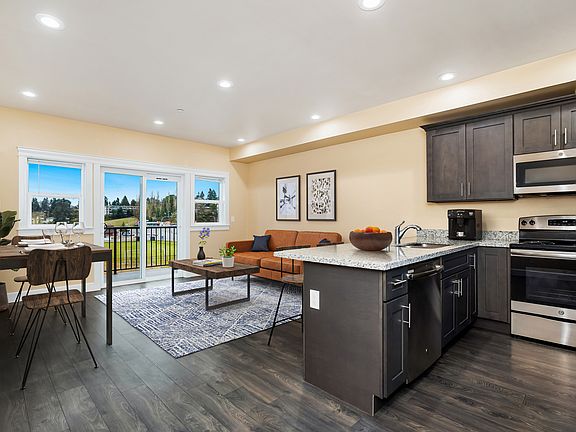 Spacious, open-concept living area with nine-foot ceilings and abundant natural light, designed for both comfort and entertaining.