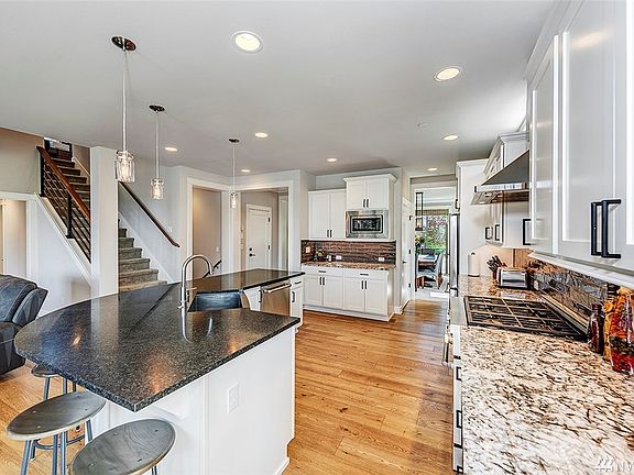 Alternate View Of The Kitchen. The Kitchen Includes A Butler's Pantry With A Walk-In Pantry. Under Cabinet Lighting And Pull-Out Shelves In The Lower Cabinets.