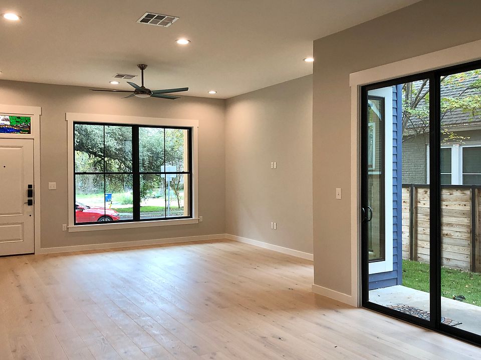 Living area is large, has a lot of natural light, and leads out to 2 patios.