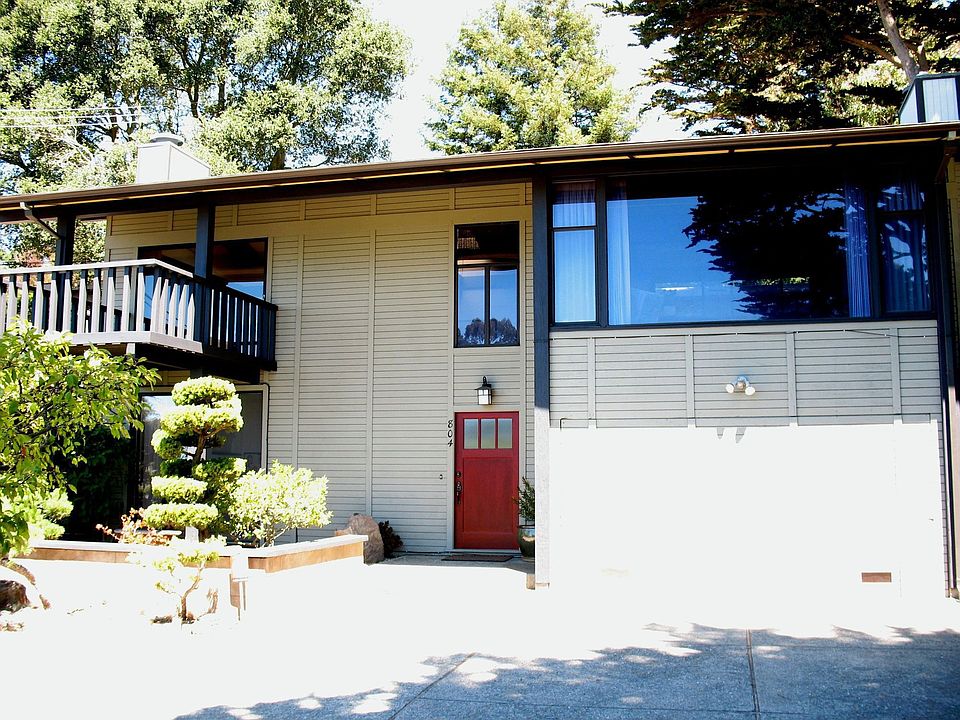 Large parking area in front.