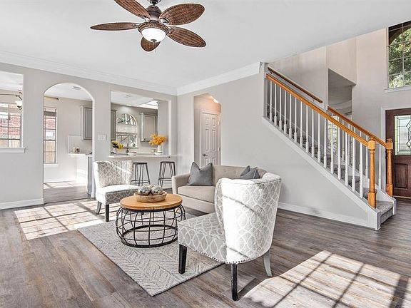 Luxury vinyl flooring, neutral grays, large windows, and ample natural light are a theme consistent throughout the home.