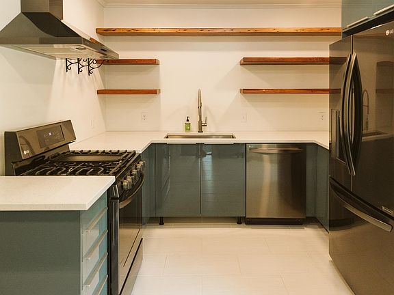 Kitchen with new appliances and a gas stove