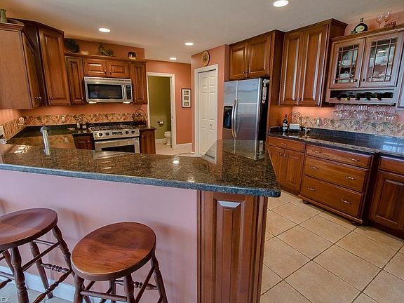 The Kitchen has many features as well like; granite counters, peninsula seating, solid cherry cabinets, tile floors, over and un
