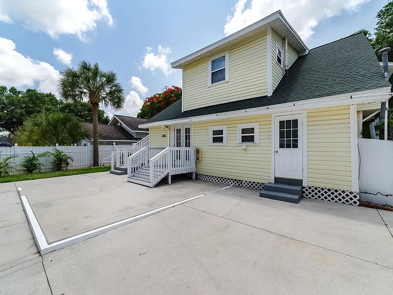 Shared backyard space with the washer and dryer conveniently located behind the white door on the right.