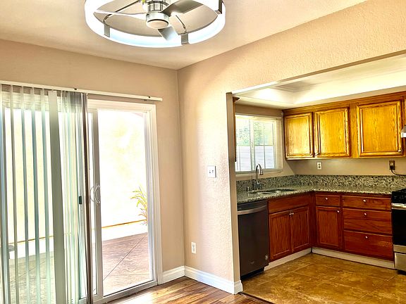 Dinning area open to kitchen with modern ceiling-fan-light combo