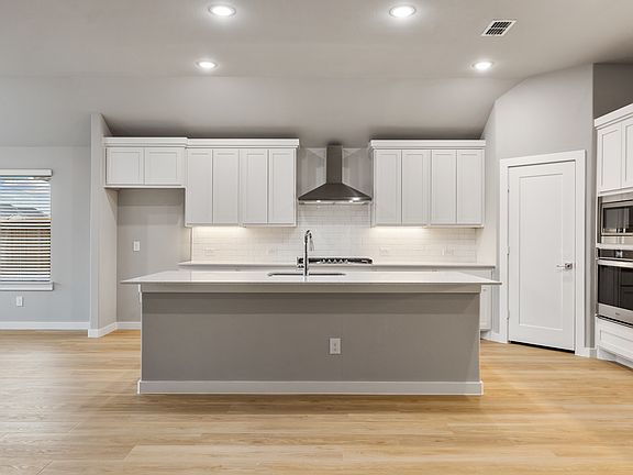 Kitchen in the Gilmour home plan by Trophy Signature Homes - REPRESENTATIVE PHOTO