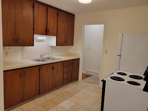 View of kitchen with storage cabinets to ceiling.