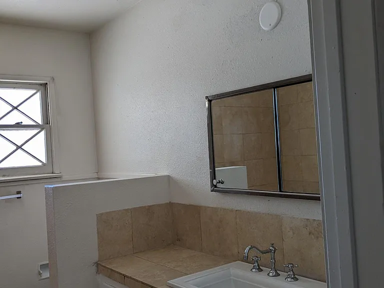 bathroom off hallway hallway travertine stone shower floors and counter top