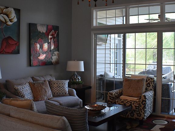 Sitting Room over looking screened in porch and back yard .