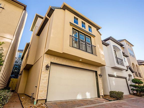 The walkway on the left leads to the front door and the gate opens to a private outdoor area.