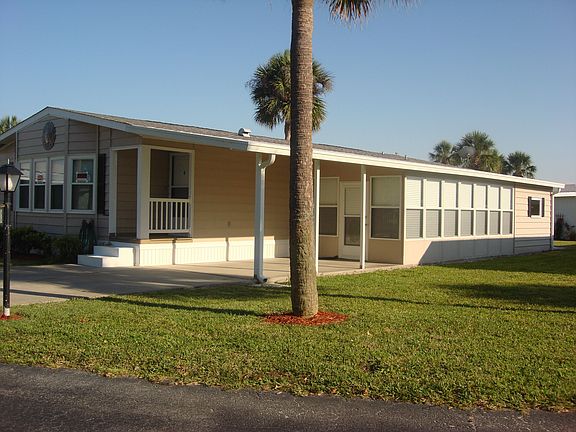 Side view showing carport, Florida Room and Workshop