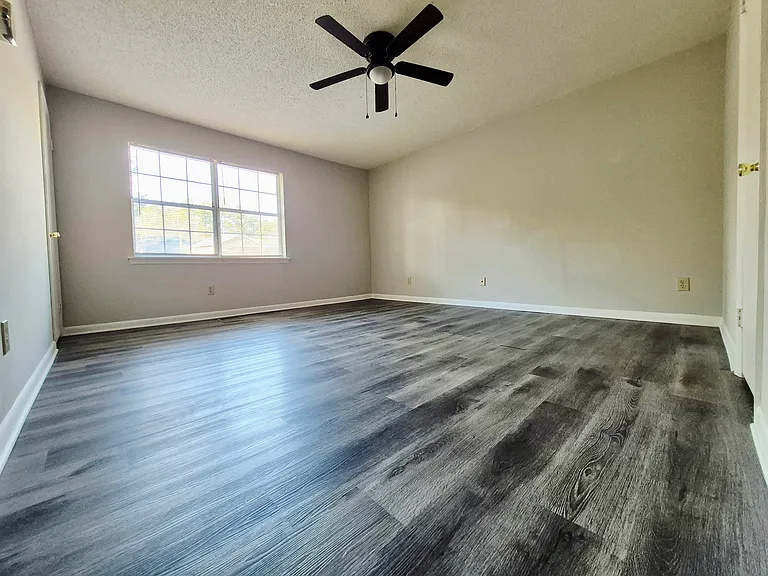 Spacious master bedroom with two closets and plenty of natural light_ample room for storage and furniture.