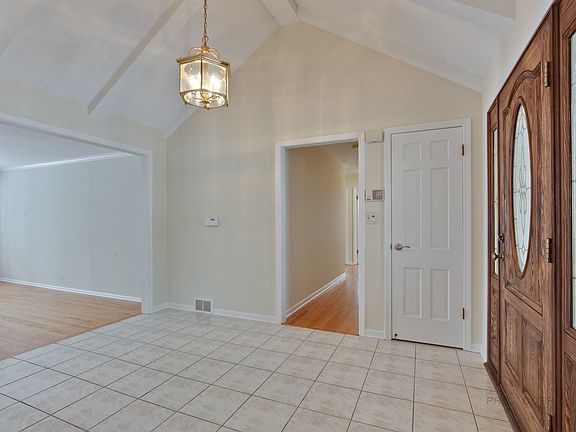 Spacious foyer with vaulted ceiling.