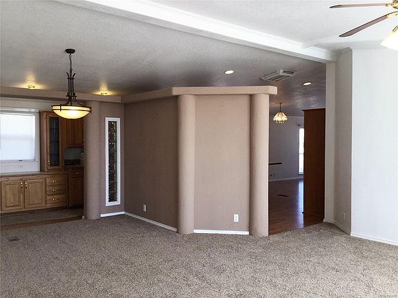 View from front entrance into family room, formal dining room and accesses into kitchen.