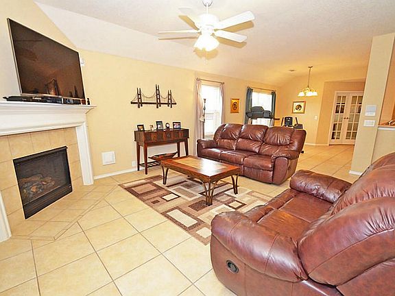 High Ceilings in this family room opening up to kitchen for ease of entertainment.