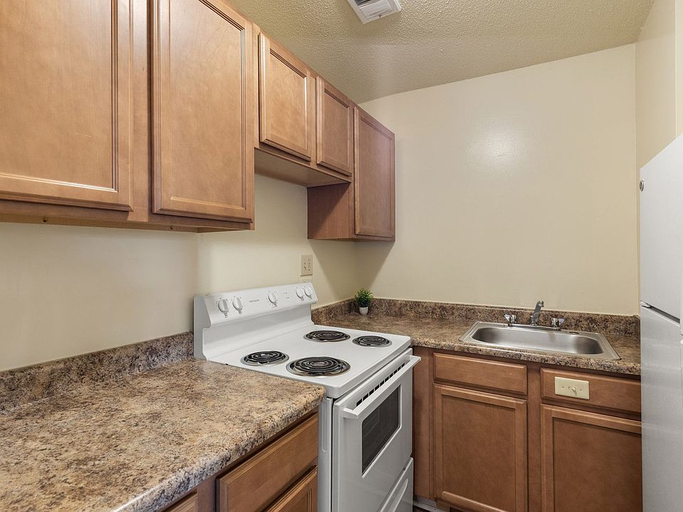 Shamrock - Kitchen with white appliances and beautiful brown cabinetry
