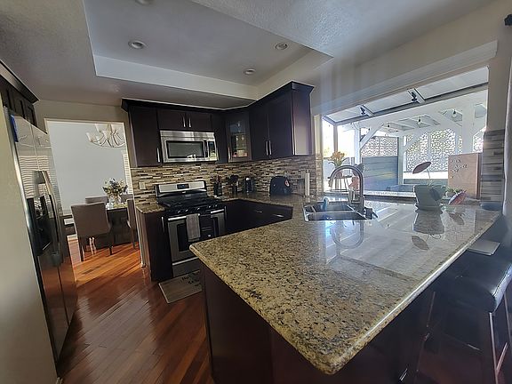Kitchen upgraded 8 years ago. Backsplash, bar counter top. Marble counter top. Dishwasher/oven/microwave/refrigerator/clothes washer/dryer included.