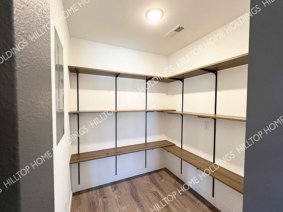 Spacious pantry. This unit is still under construction. Photo of neighboring unit with similar finishes.