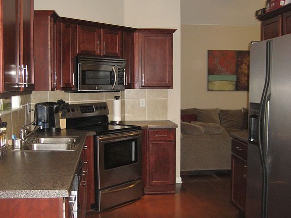 Gleaming hardwoods & stainless appliances in kitchen