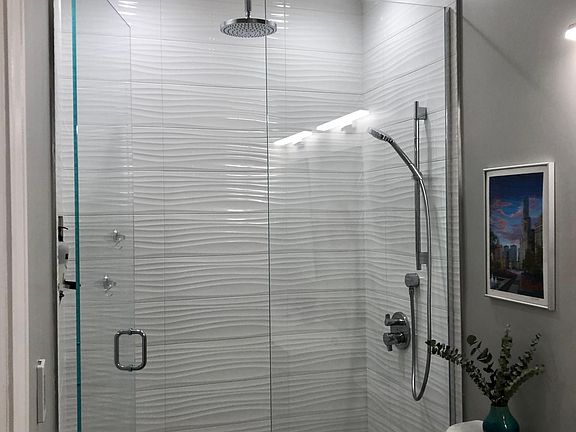 Master Bathroom with dual vanity. Spacious rainfall shower with additional adjustable wand spray head.