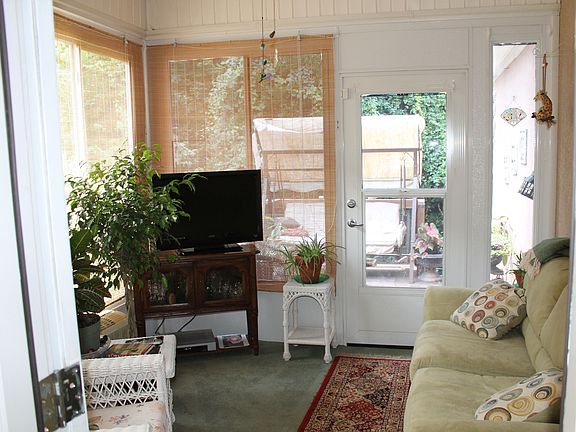 Sunroom that leads to deck and backyard.