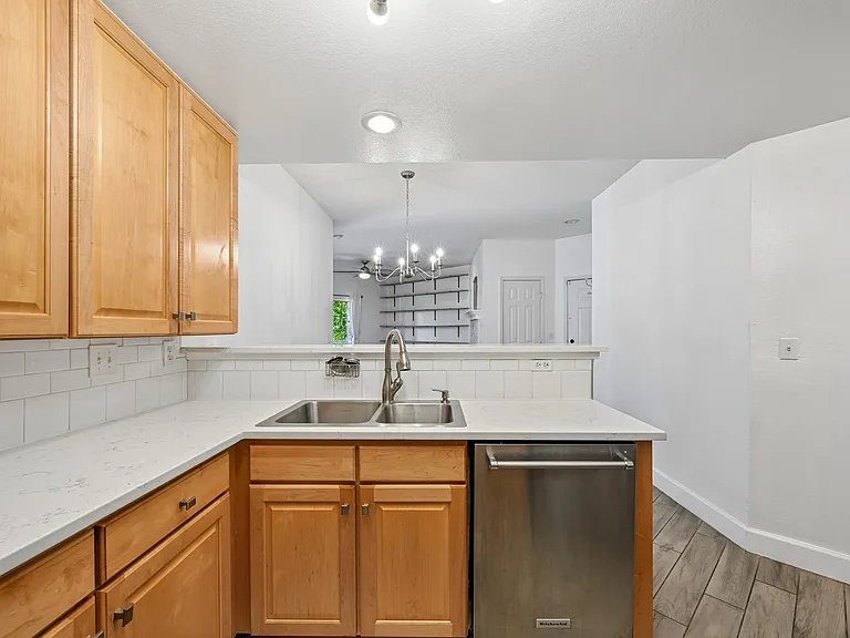 Quartz countertops, garbage disposal and stainless steel appliances.