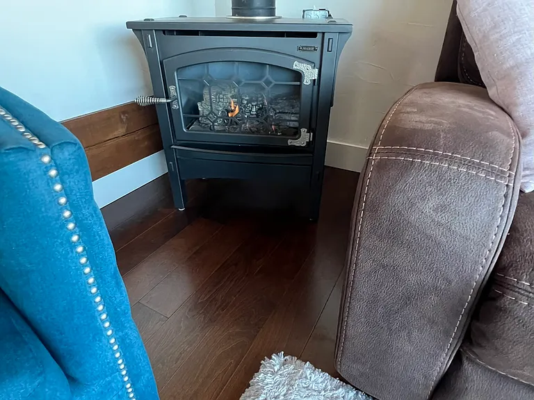Gas log stove in living room corner