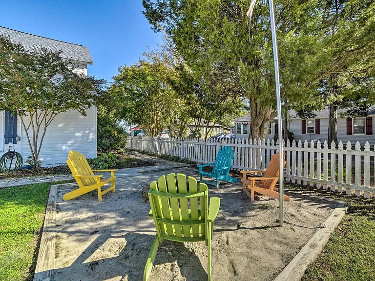 Fire pit with colorful Adirondack chairs.