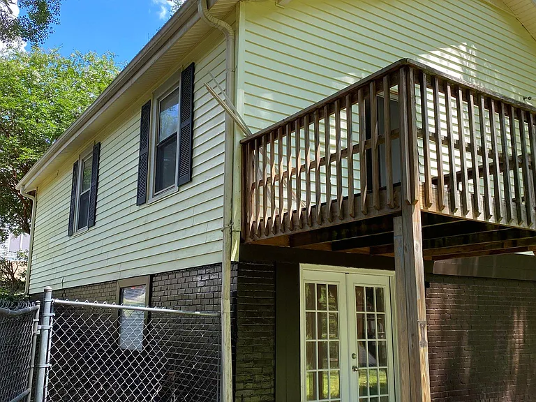 Outside door to basement room with deck overhead