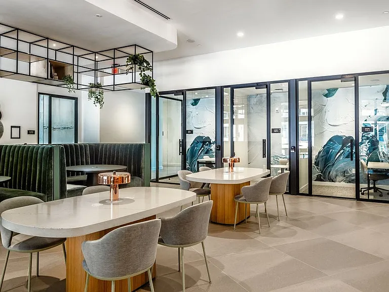 Resident lounge with coworking spaces and private work pods