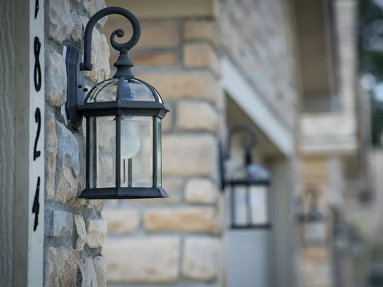 Enjoy thoughtful design touches like this elegant lantern, adding character and warmth to the home's exterior.