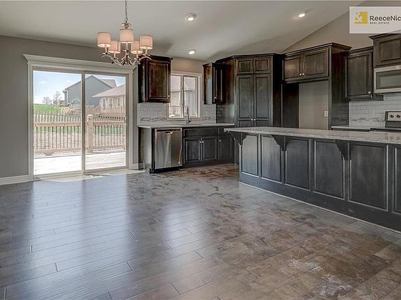 Kitchen offers stainless steel appliances (microwave, dishwasher, electric range), garbage disposal, custom beech cabinetry with crown molding, granite counter tops and tiled backsplash.Dont miss the concealed cabinet door hinges, walk-in storage pantry andUSB charging outlet.