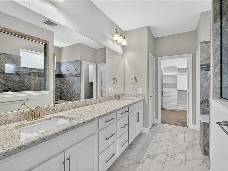 Double vanity with undermount sinks and light-toned countertops