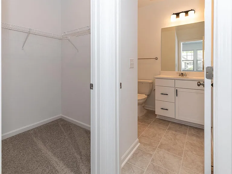 View of the full walk-in closet adjacent to the bathroom.