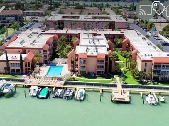 Photo of Boca Shores condo complex from Intracoastal, fishing from pier and dolphin siting daily