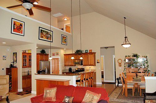 Vaulted ceiling is open to second floor landing. Bamboo flooring in kitchen and dining area.