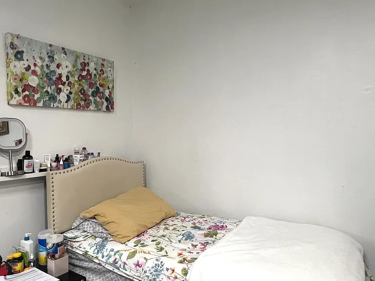 Single guest bed with a bedside table