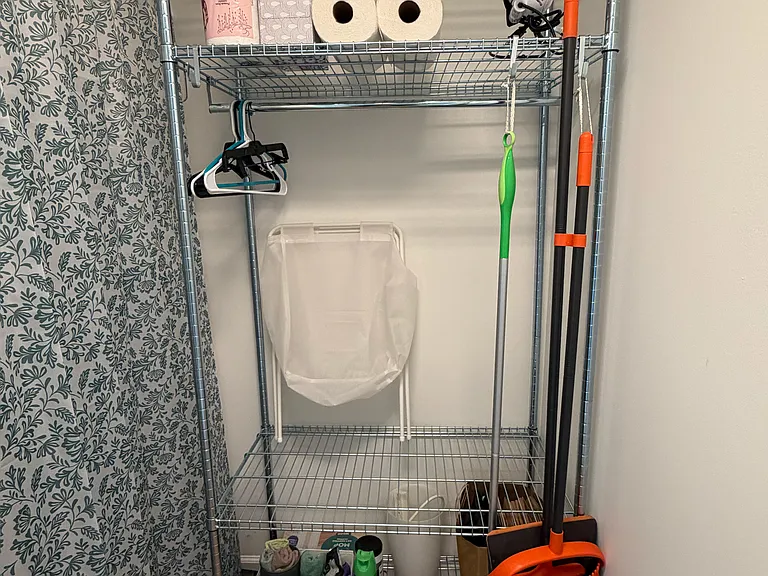 Front Storage Closet (1 of 2) with Clothing/Shelf Rack, Cleaners, Vacuum, and Spare Household Items