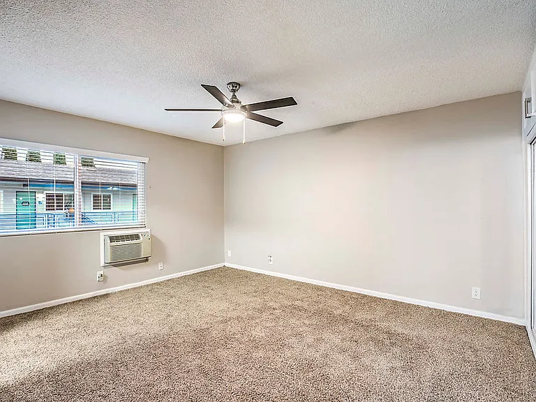 The Island Apartments unfurnished bedroom with ceiling fan
