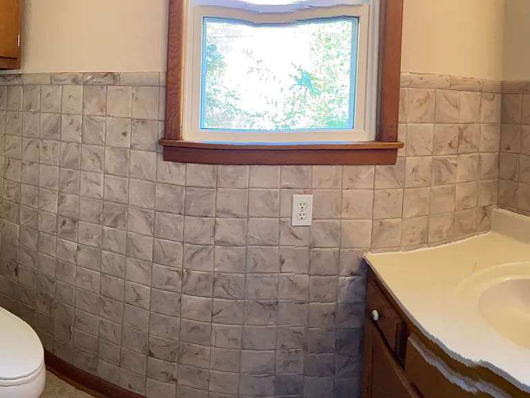 Toilet and vanity area off of laundry room