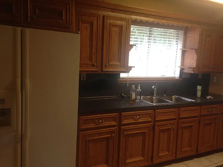 Plenty of space in the kitchen. Newly installed kitchen sink and faucet facing out towards the back patio. Newly installed windows allow nature light and outdoor breeze into the home. *Refrigerator not included