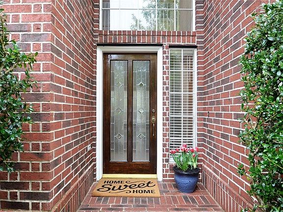 There's a cozy front porch to greet your guests.  Note the full leaded glass front door.