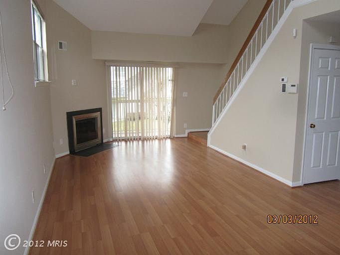 Living/Dining combo with a cozy fireplace and a sliding door which leads to a balcony with nice view of green common area