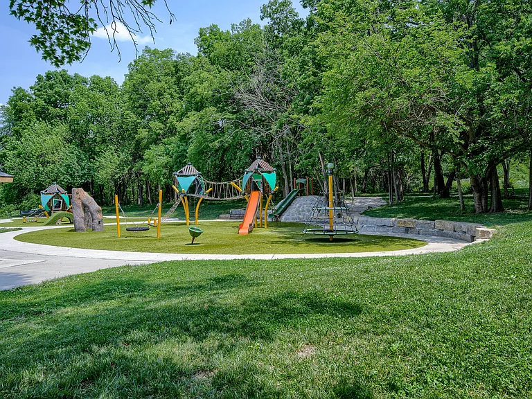 Pleasant Lea Park 1 block away featuring covered picnic tables, recently updated playground equipment, slides, and swings