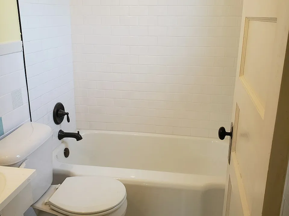 Bathroom. New shower tile and restored bathtub.