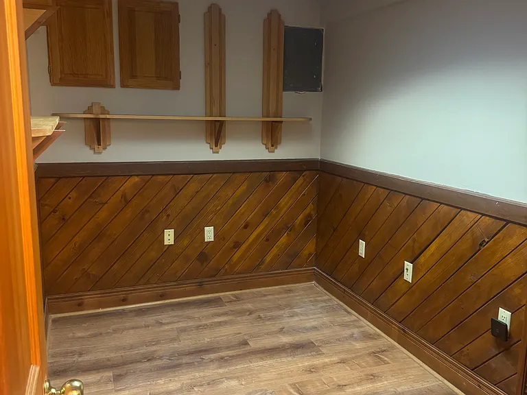 Den/office with wood paneling